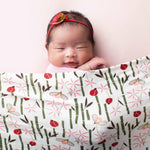 Square baby swaddle blanket with a pink insect and bug pattern