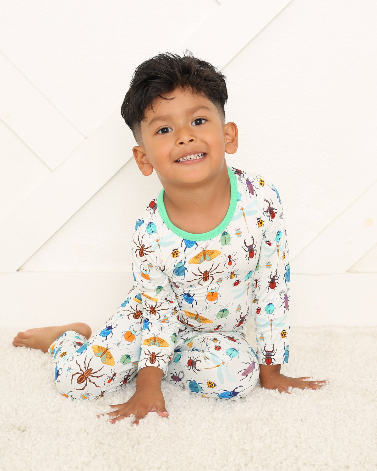 Two-piece long sleeve baby pajama set with bug print top and matching pajama bottoms