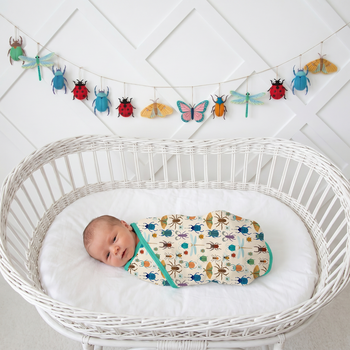 Square bamboo baby swaddle blanket with a playful bug print