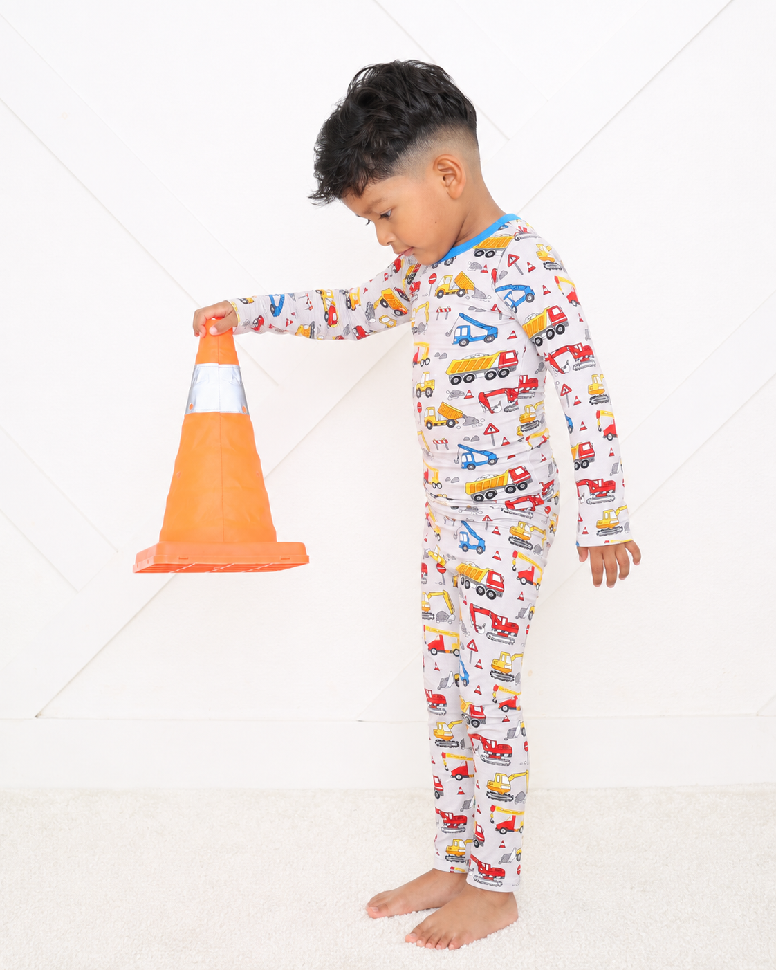 Two-piece long sleeve pajama set with builders construction print top and matching pants