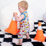 Sleeveless baby shortall in a builders print with snap closures at the shoulders and legs