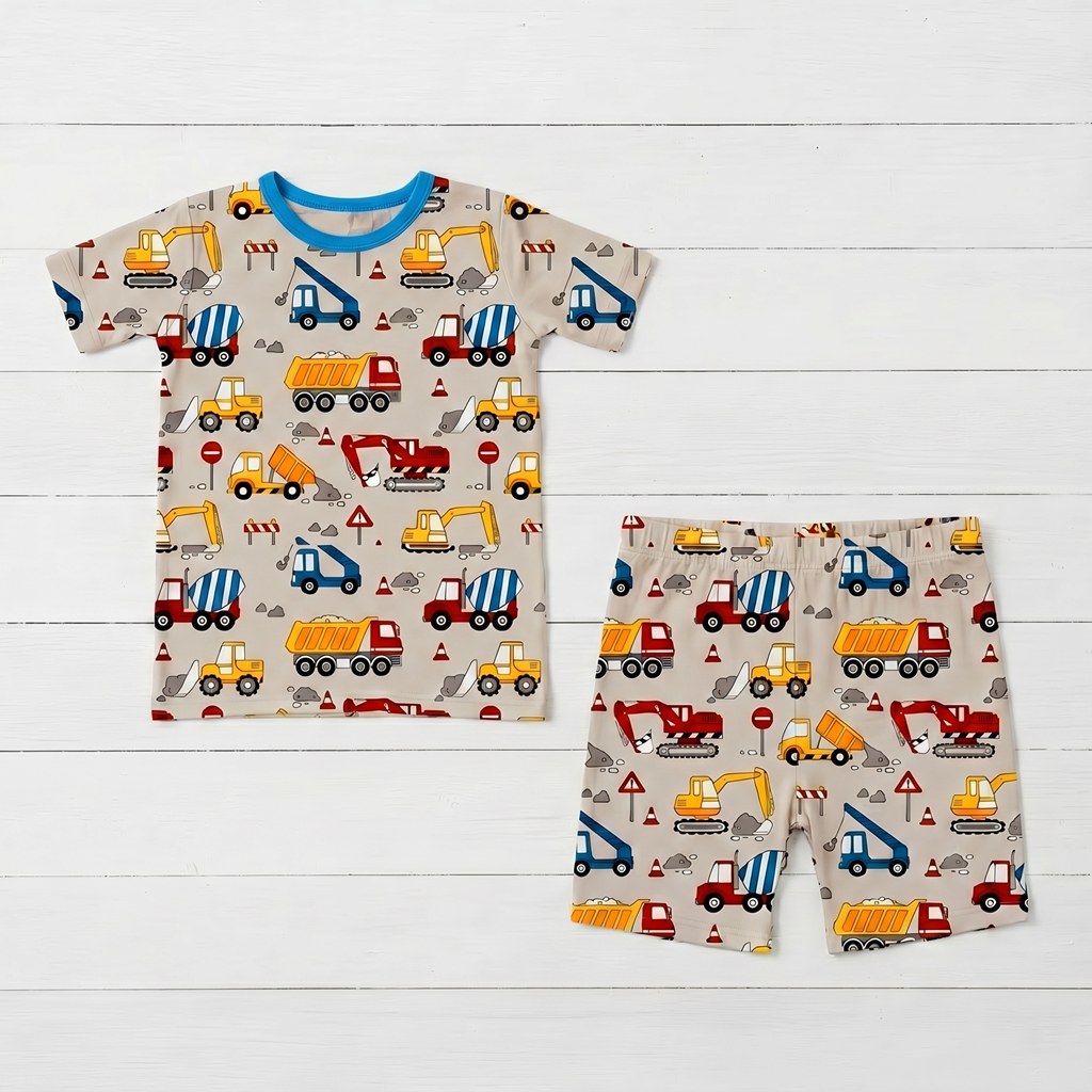 Two-piece kids pajama set with short sleeve top and matching shorts in a builders construction print