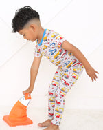 Two-piece pajama set with short sleeve top and long pants in a construction builders print