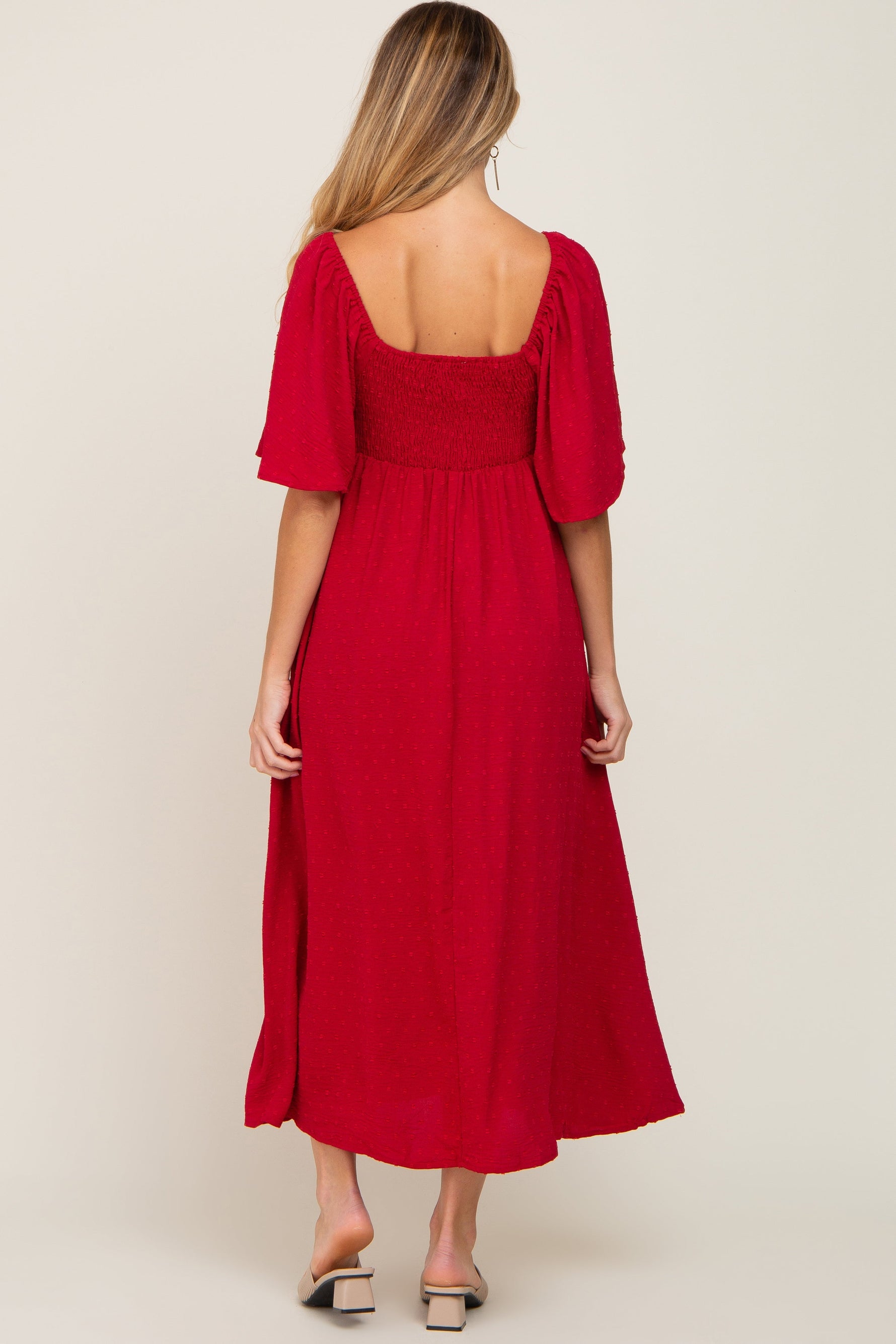 PinkBlush Burgundy Textured Dot Maternity Midi Dress with front tie and ruffle sleeves, worn by a pregnant model.