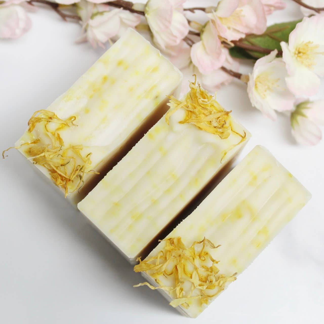 Unscented calendula bar soap with flecks of dried calendula petals throughout the bar