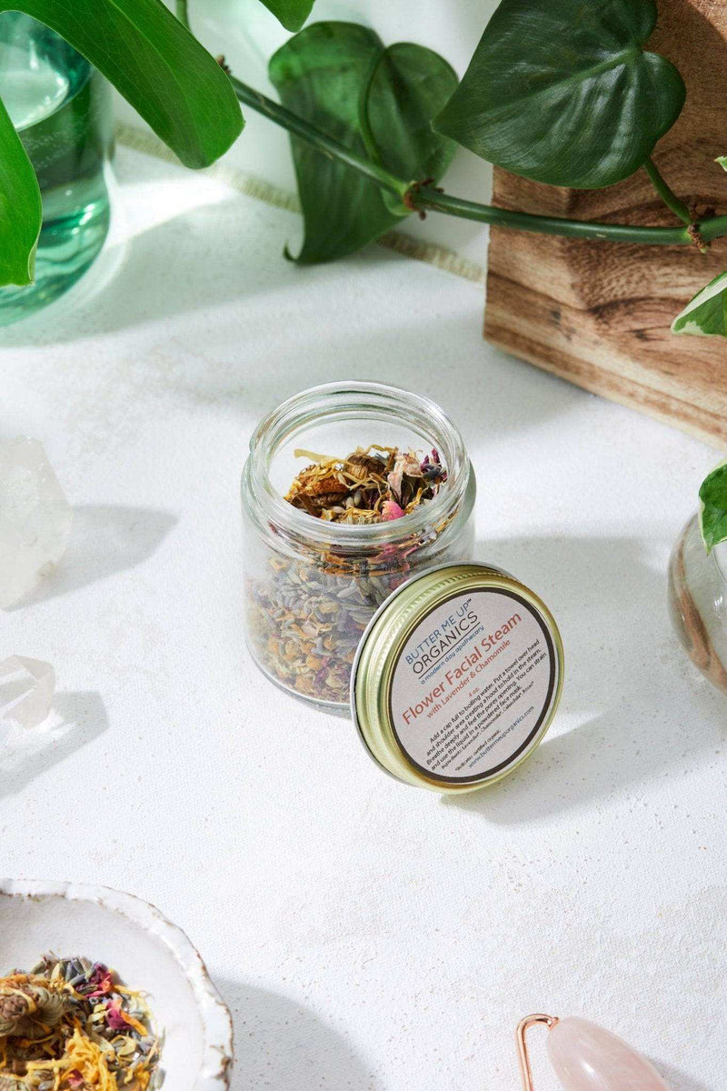 Calming Healing Facial Steam in a jar with natural ingredients surrounded by plants and a peaceful setting.