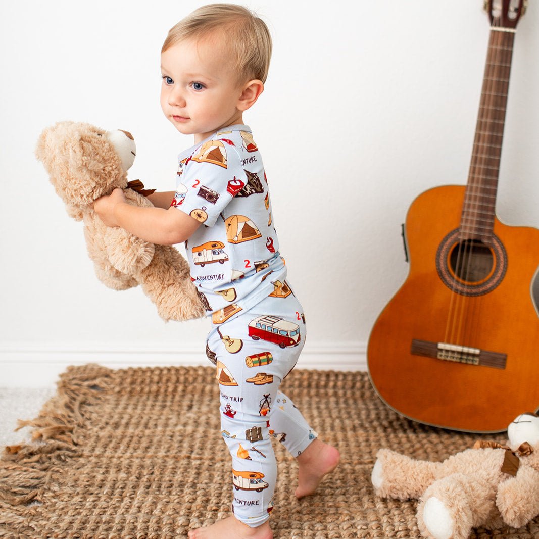 Two-piece baby pajama set with short sleeve top and pants in a camping-themed print