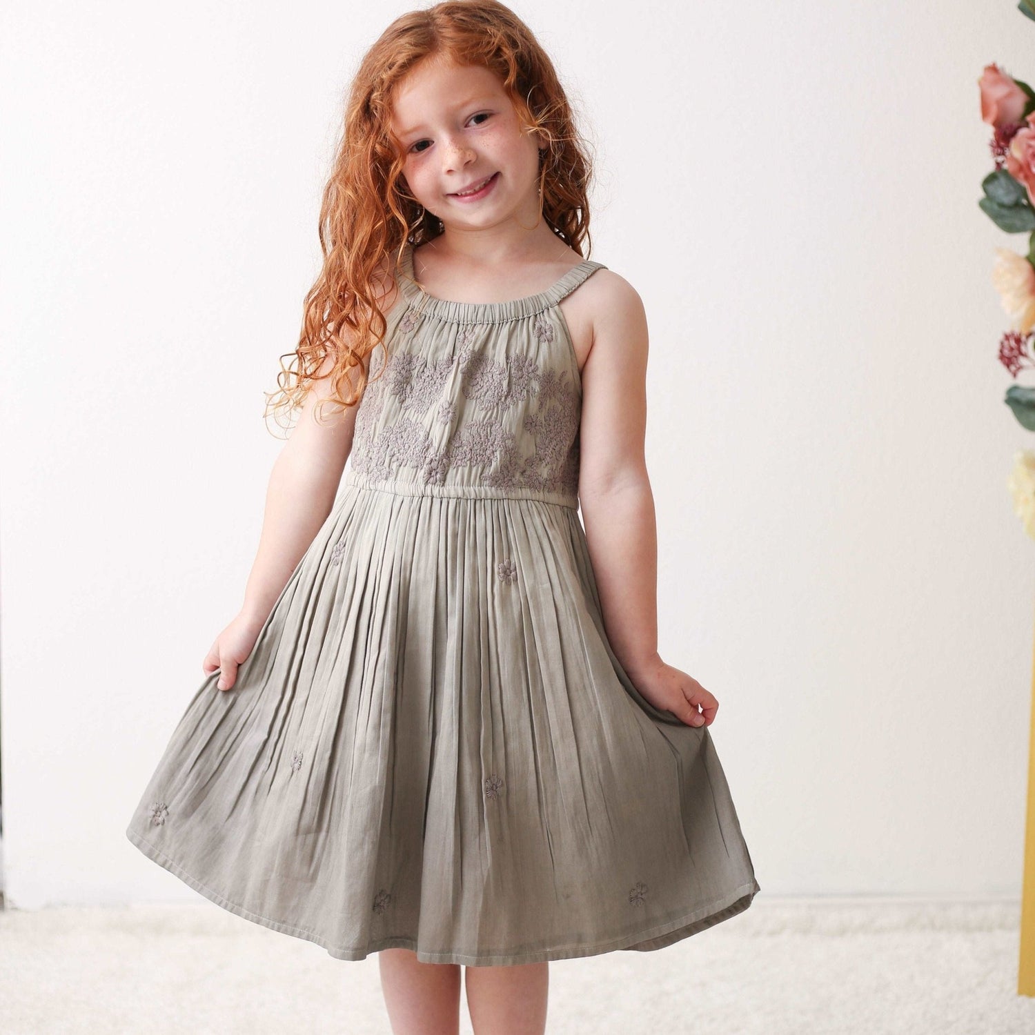 Grey ombre baby dress with a round neckline and embroidery on the bodice, cut with a full twirly skirt.