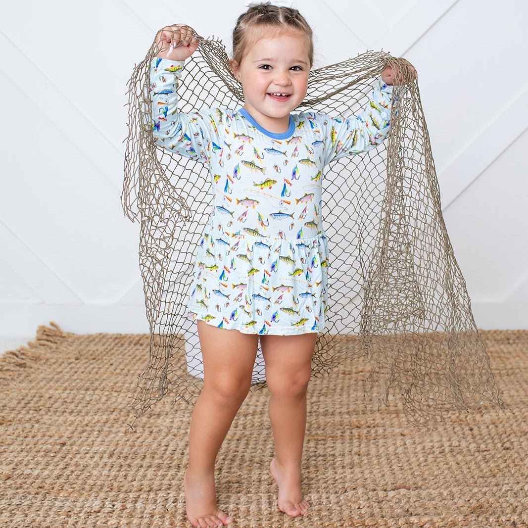 Bodysuit dress with long sleeves and a colorful fall fish print, worn by a smiling child.