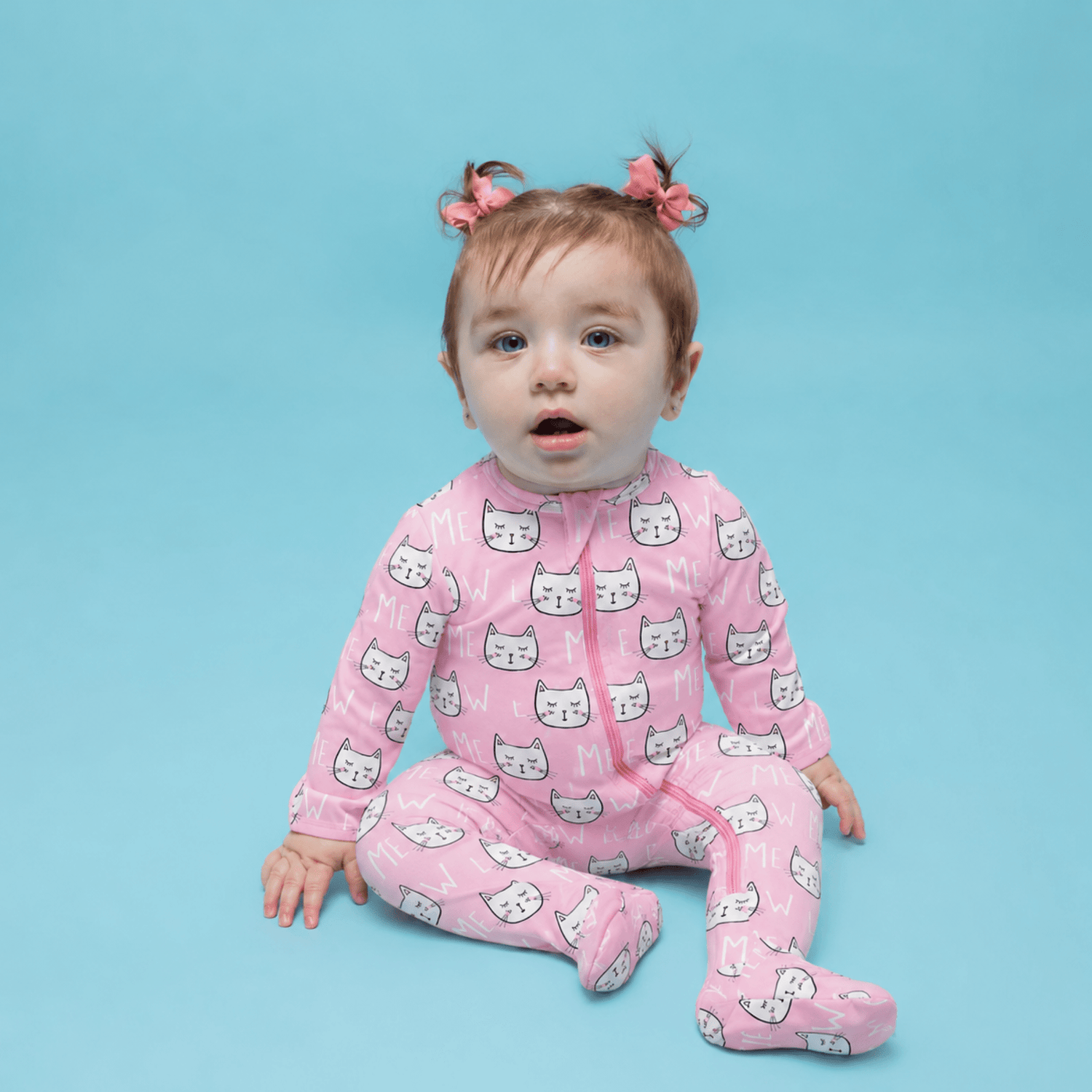 Baby footie pajamas in a kitty cat print with a two-way front zipper and covered hand openings
