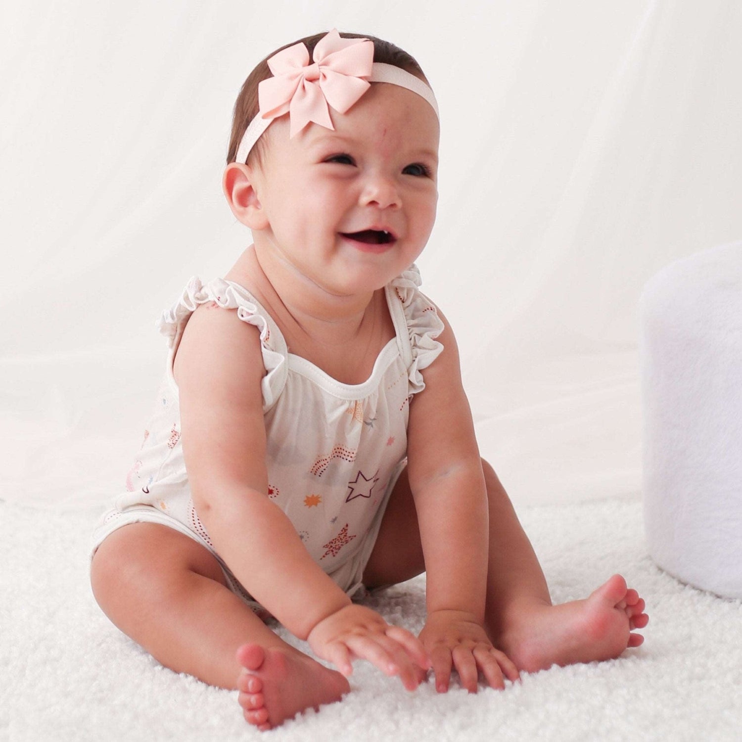 Bubble romper with flutter sleeves in a celestial star print, snaps along the legs