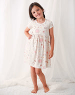 Celestial baby dress in soft pink, twirl-friendly skirt, worn by a young child