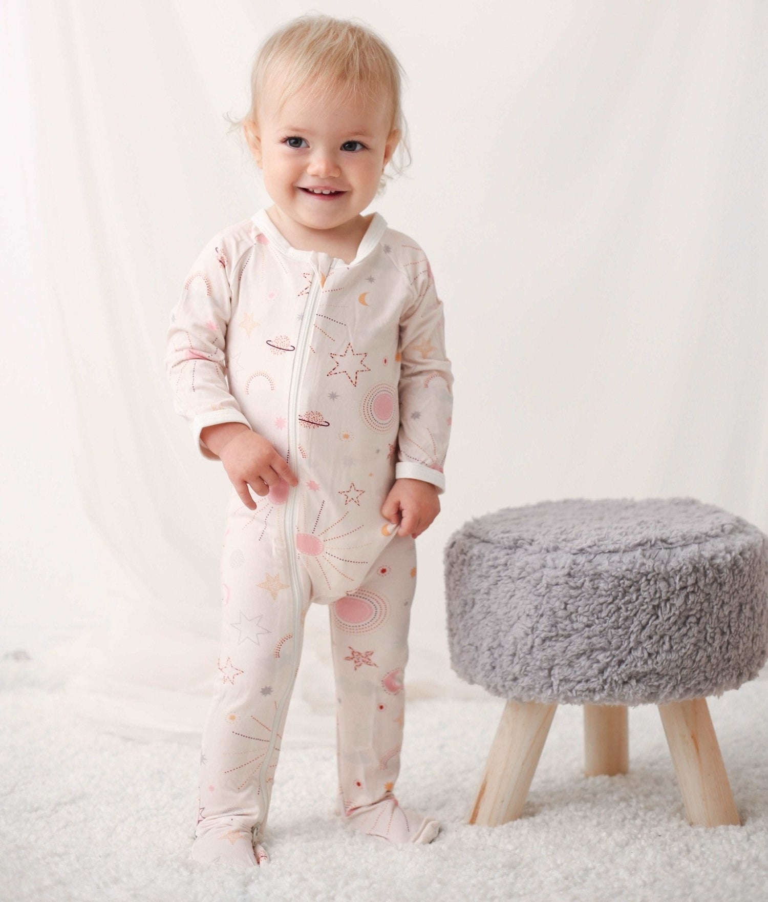 Baby footie pajamas in a celestial star print with full-length zipper and covered feet