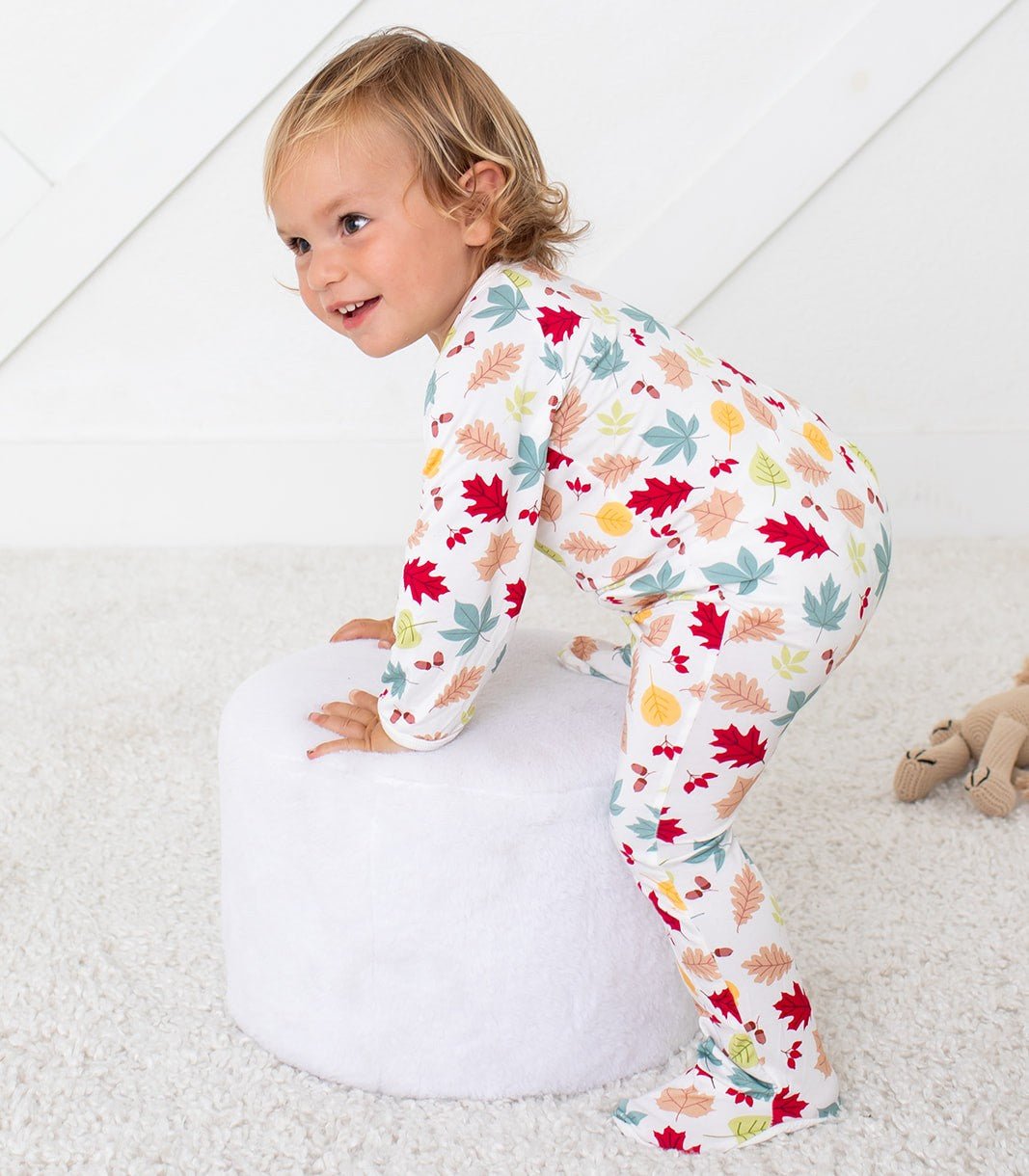 Baby footie pajamas in the Charmleaf leaf print with covered feet and a full-length zipper