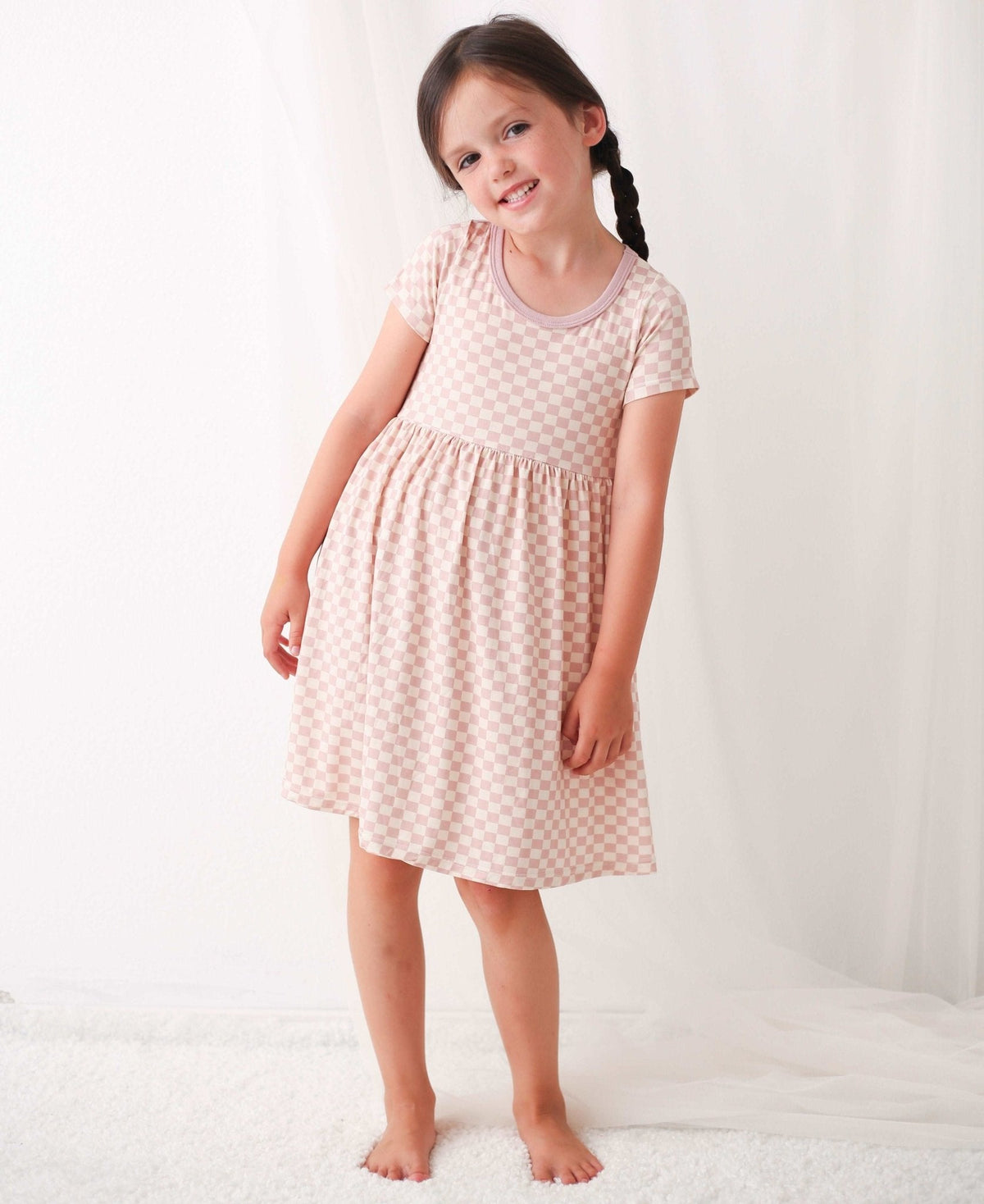 Baby dress with pink and white checkered pattern, short sleeves and a full twirl skirt