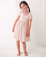 Baby dress with pink and white checkered pattern, short sleeves and a full twirl skirt