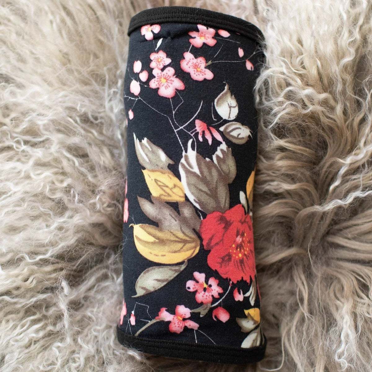 Black baby swaddle blanket with a white cherry blossom branch print, spread out flat