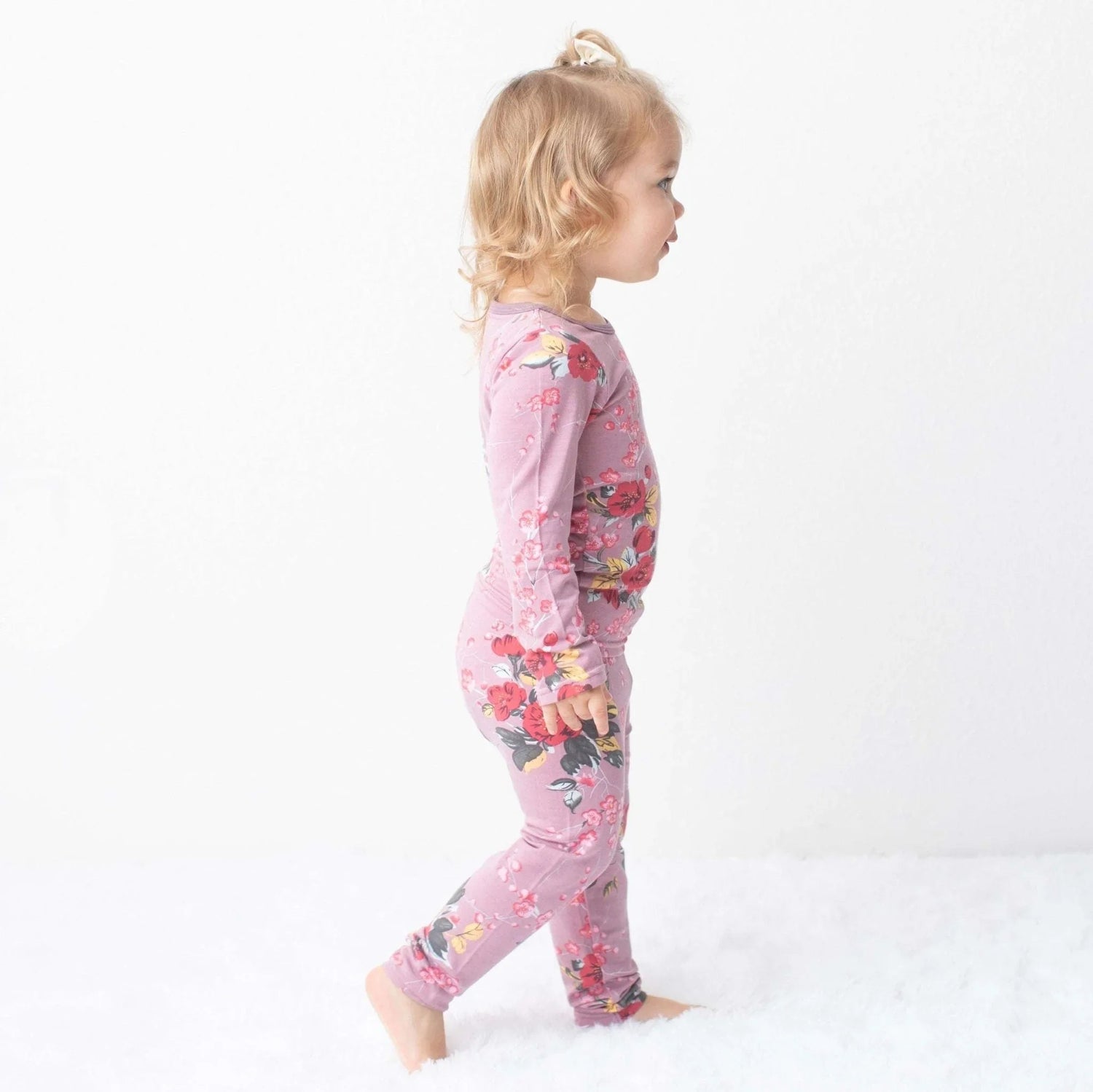 Two-piece baby pajama set in mauve with a cherry blossom print, matching long-sleeve top and pants.