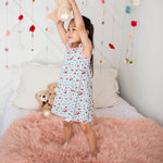 Flutter sleeve dress in a cherry print on a light background, with short ruffled sleeves and a twirl skirt