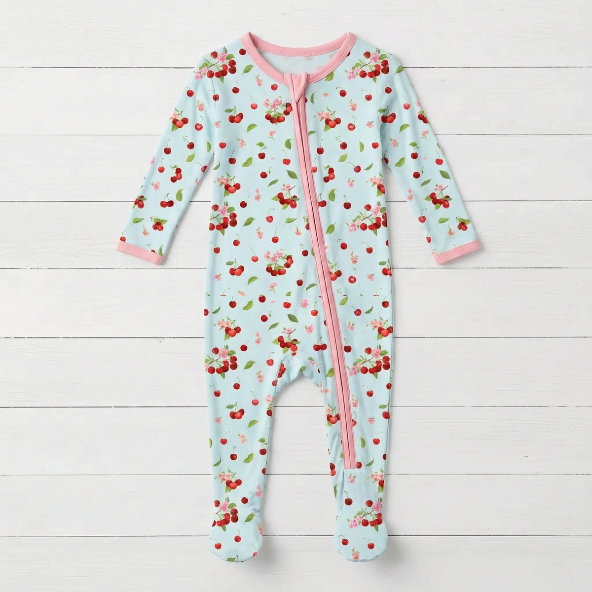 Baby footie pajamas in cherry print with a two-way front zipper and covered feet