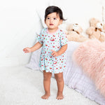 Short-sleeve baby bodysuit dress in a cherry print, with a flared skirt and snaps at the bottom