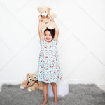 Short sleeve girls dress with an allover red cherry print on a light background