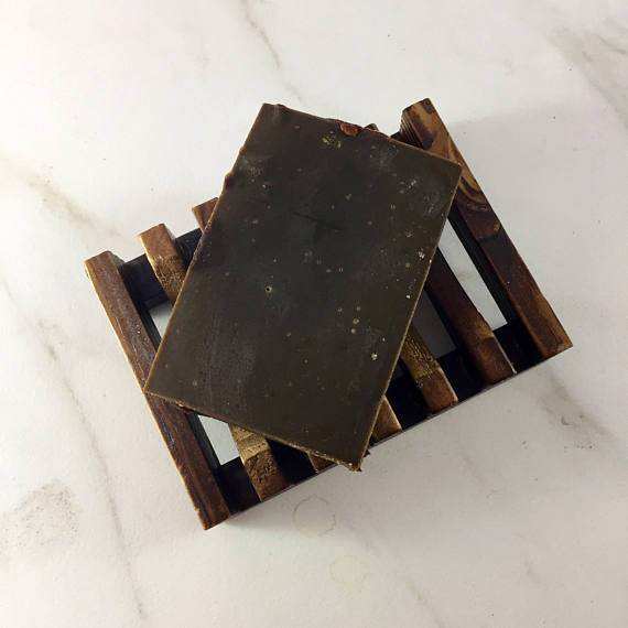 Organic Chocolate Shampoo bar on a wooden soap dish, made with raw cocoa and cocoa butter.