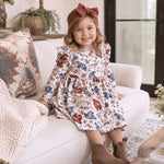 Cowgirl twirl dress with cowboy hat and floral print, ruffle-trimmed sleeves, gathered skirt, and button-back closure.
