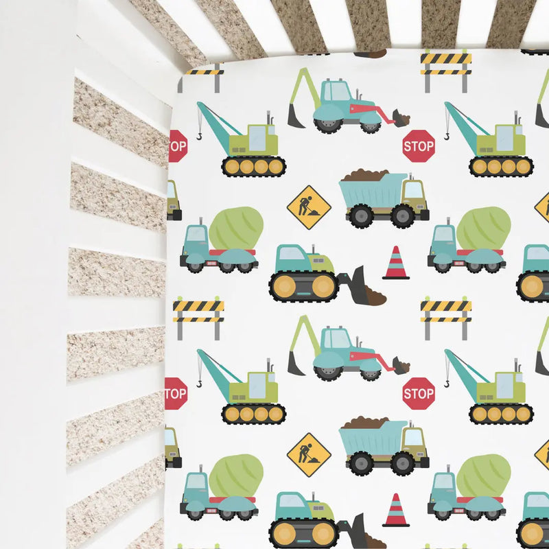 Construction trucks fitted crib sheet in soft fabric, perfect for standard cribs.