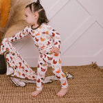 Two-piece baby pajama set with matching long-sleeve top and pants in a cooped-up chicken print