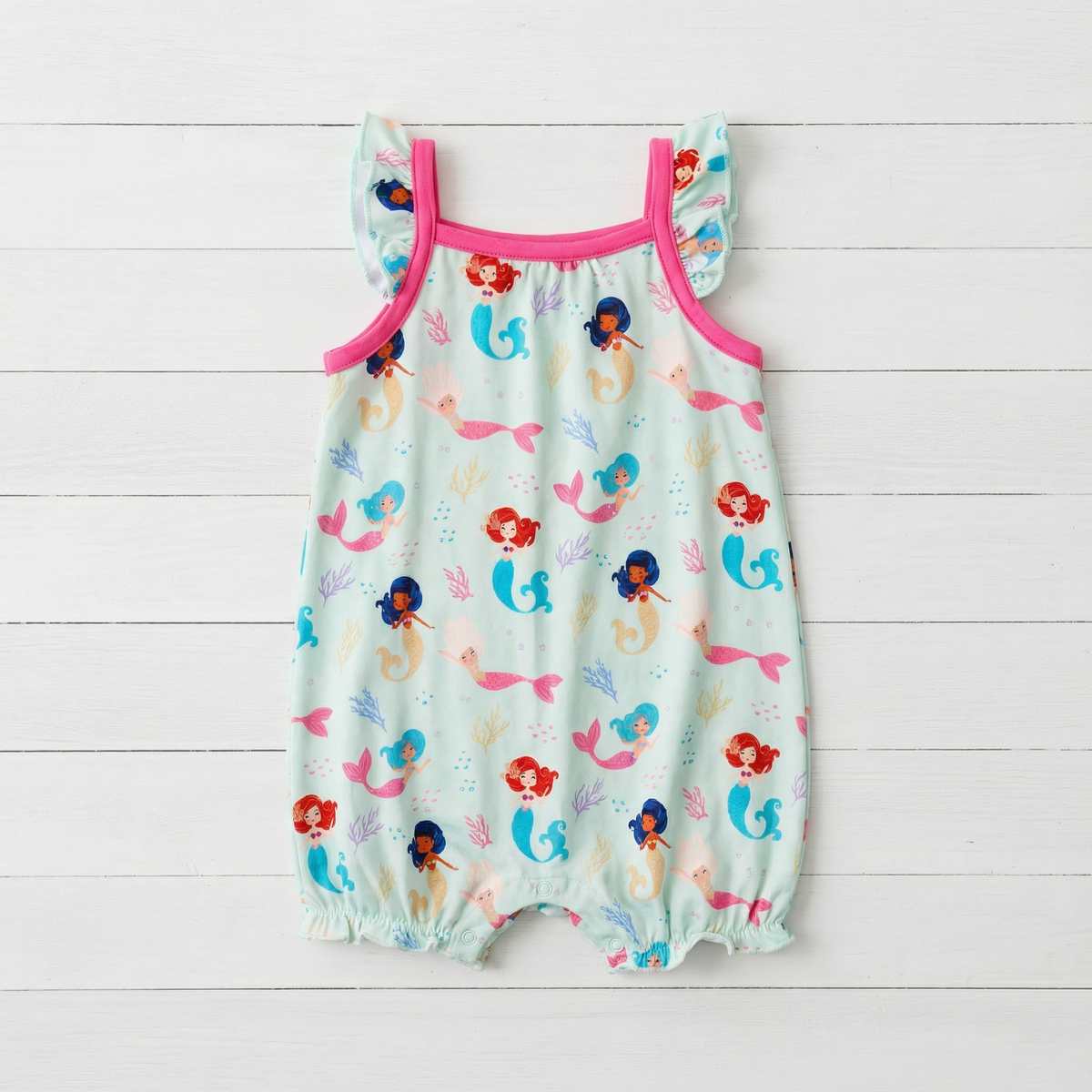 Coral bubble romper with flutter sleeves and snap closures along the legs