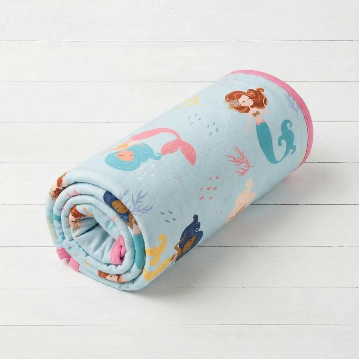 Oversized square baby swaddle blanket with a coral print in soft pink and cream tones