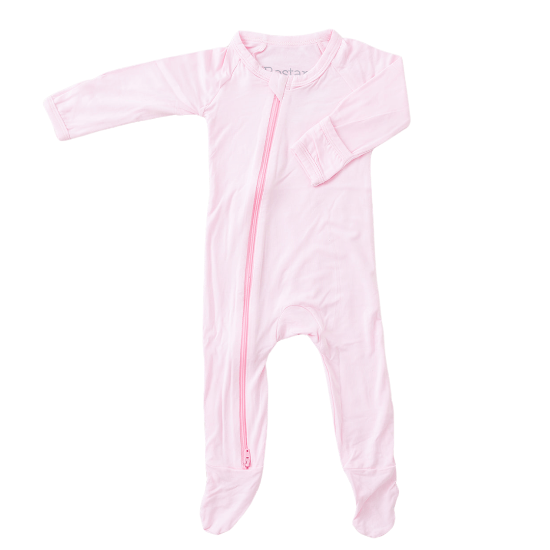 Baby pink footie pajamas with a full-length two-way zipper and footed legs.