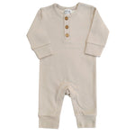 Baby wearing a soft, organic long sleeve cotton romper from LUCY LUE ORGANICS, gentle on skin.