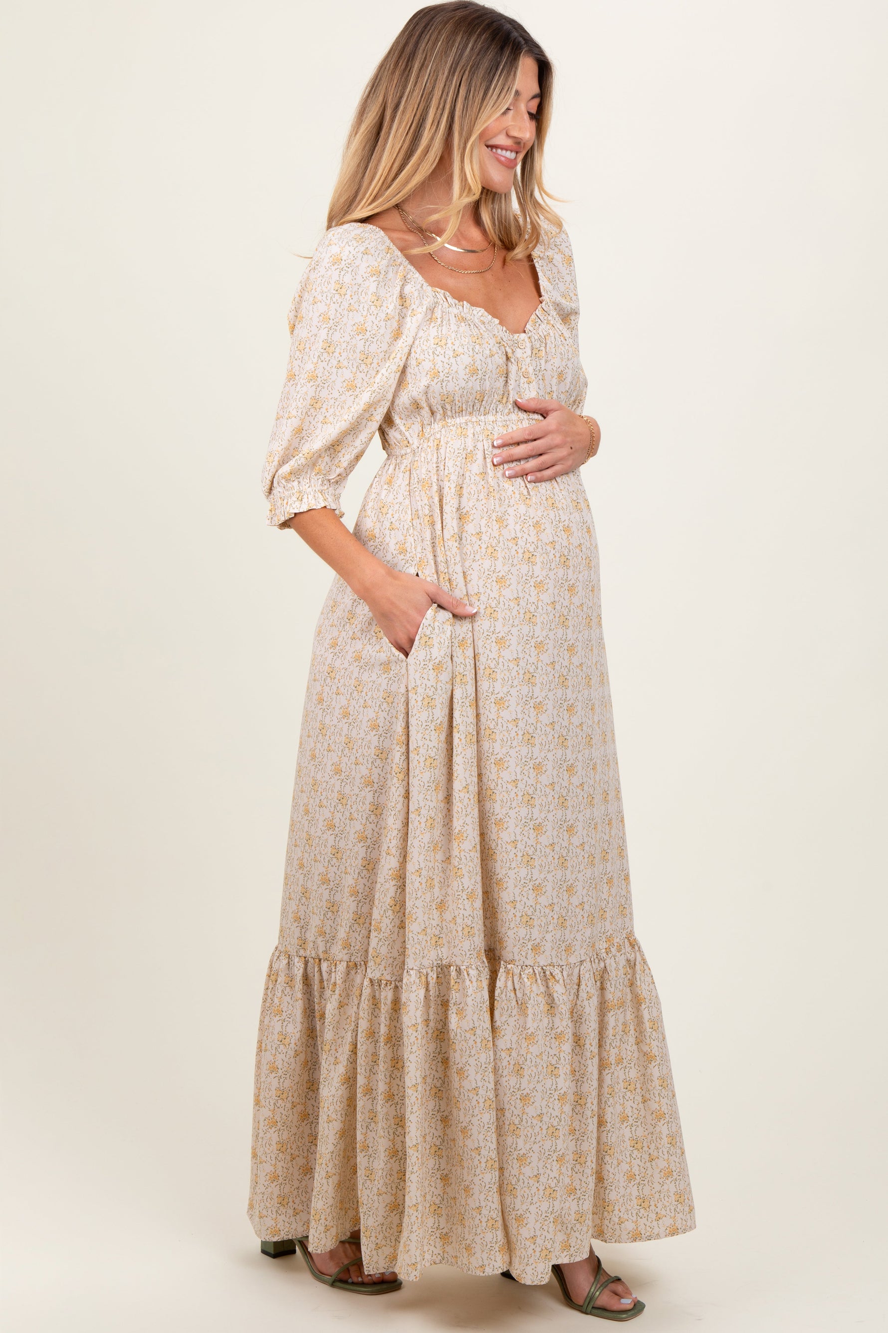 Model wearing a PinkBlush Cream Floral Sweetheart Neckline Maternity Maxi Dress, posing gracefully.