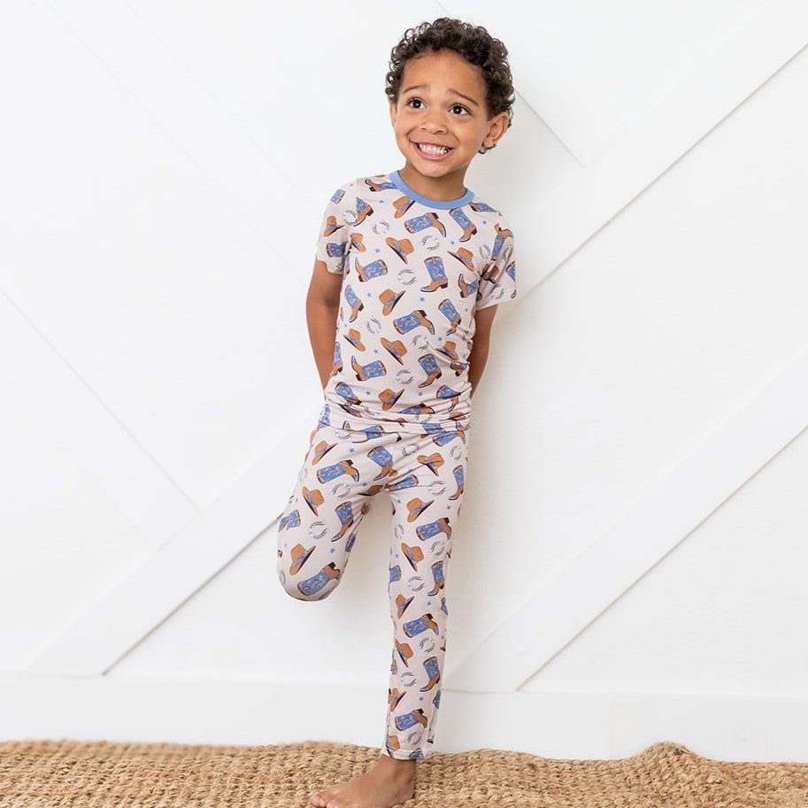 Short sleeve baby pajama set with brown and blue western cowboy boot print top and matching pants