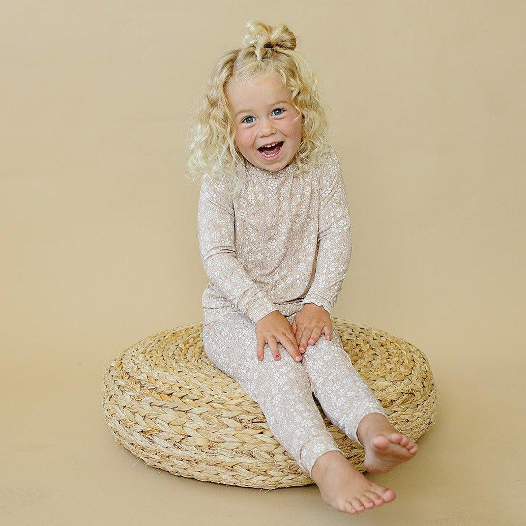 Two-piece baby pajama set with top and pants in a dainty ditsy floral print