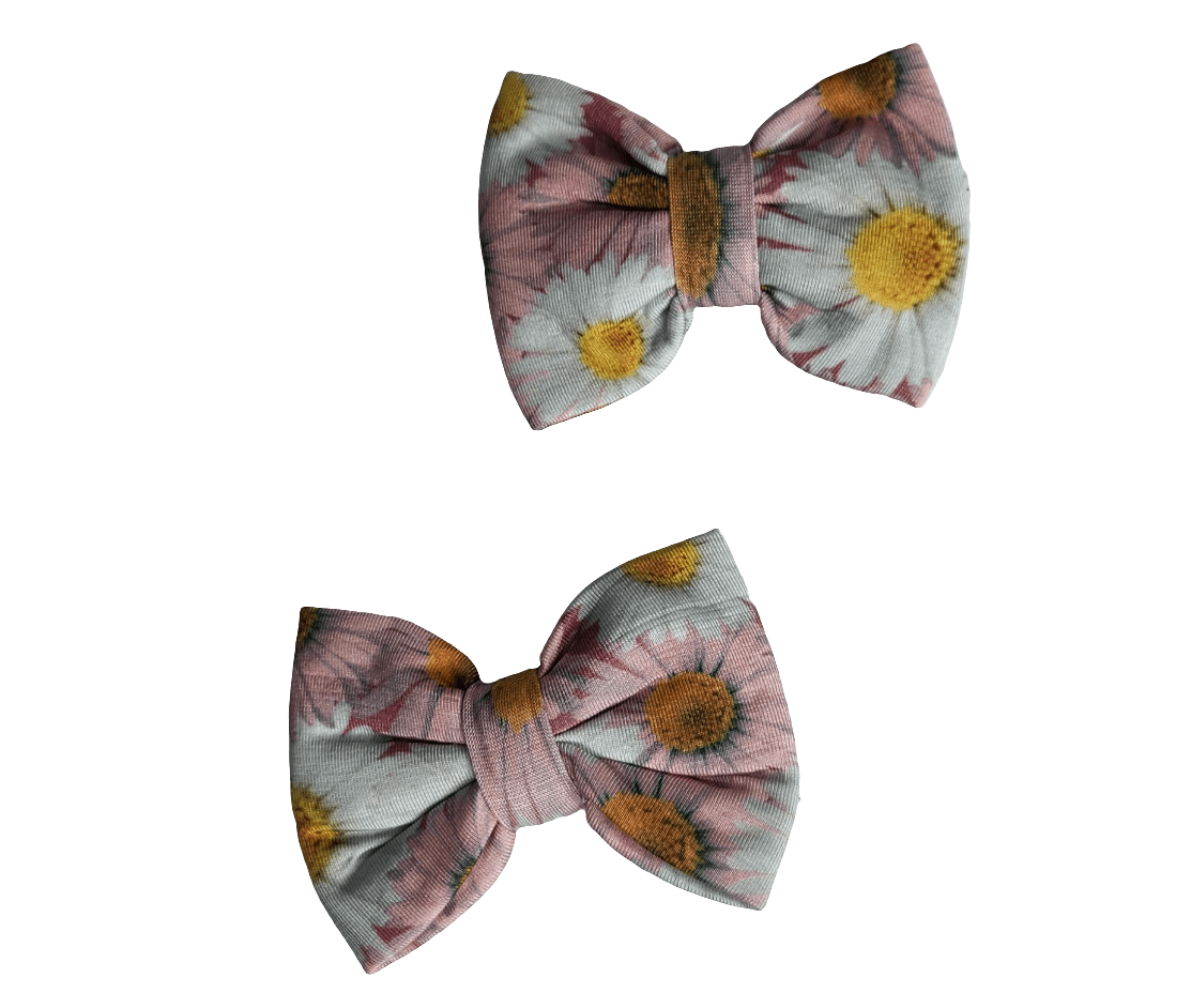 Pair of pink daisy print piggie hair bows made of bamboo fabric