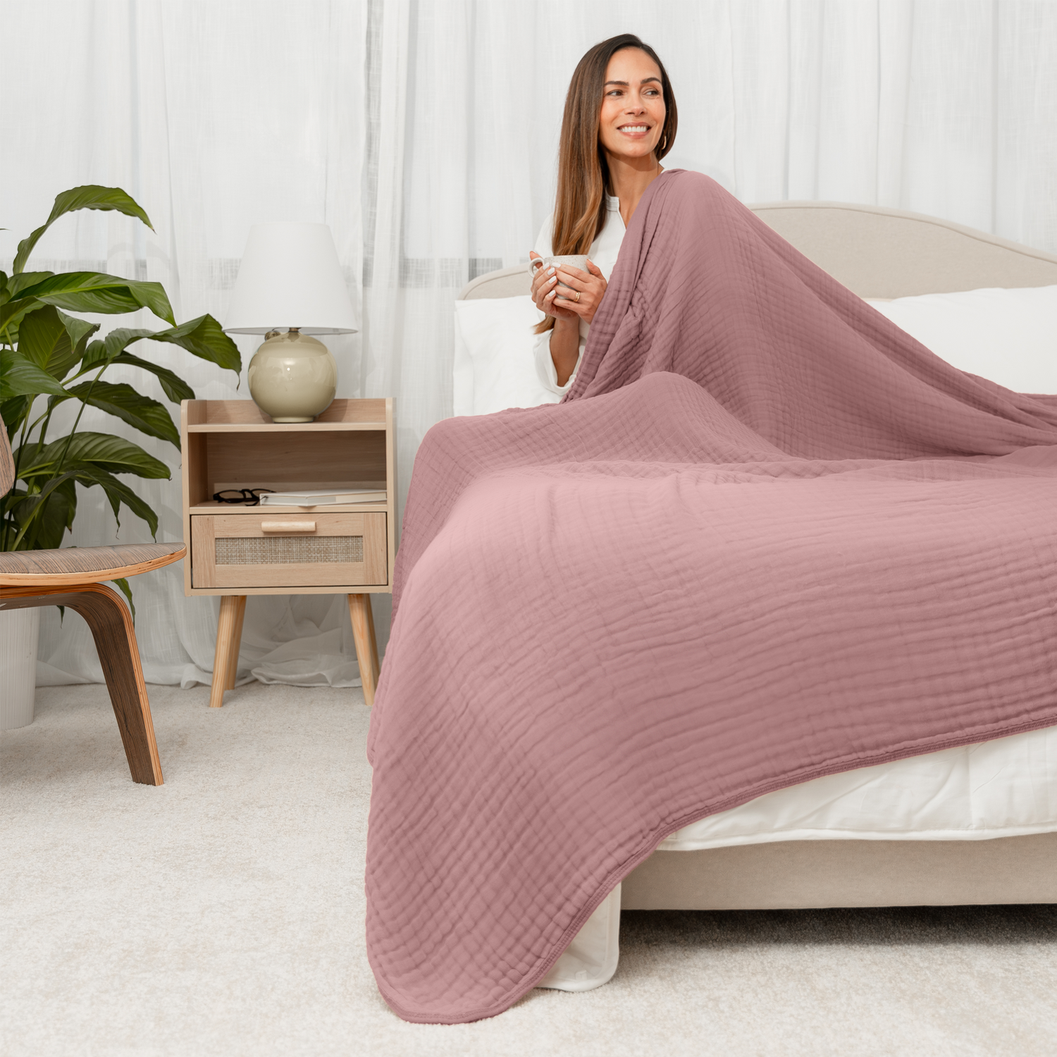 Mauve six-layer muslin cotton blanket with quilted texture, folded and shown in queen size.