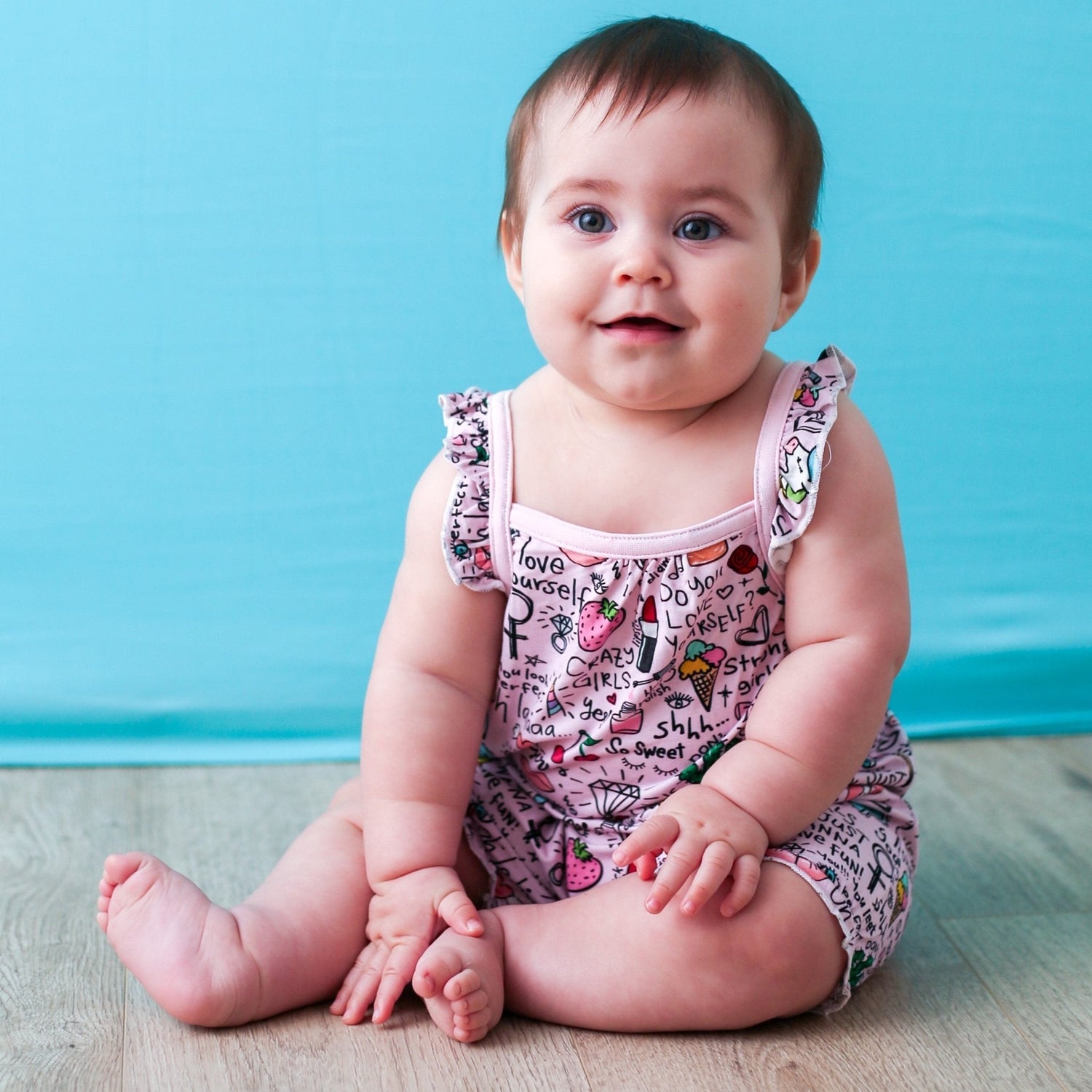 Bubble romper with flutter sleeves in a pink Dear Diary print, snaps along the legs