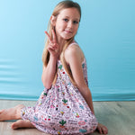 Sleeveless racer-back toddler dress in pink, styled for twirling and everyday play.