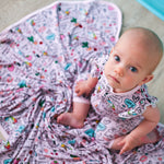 Dear Diary swaddle blanket with a soft printed pattern, spread out flat to show its large square shape