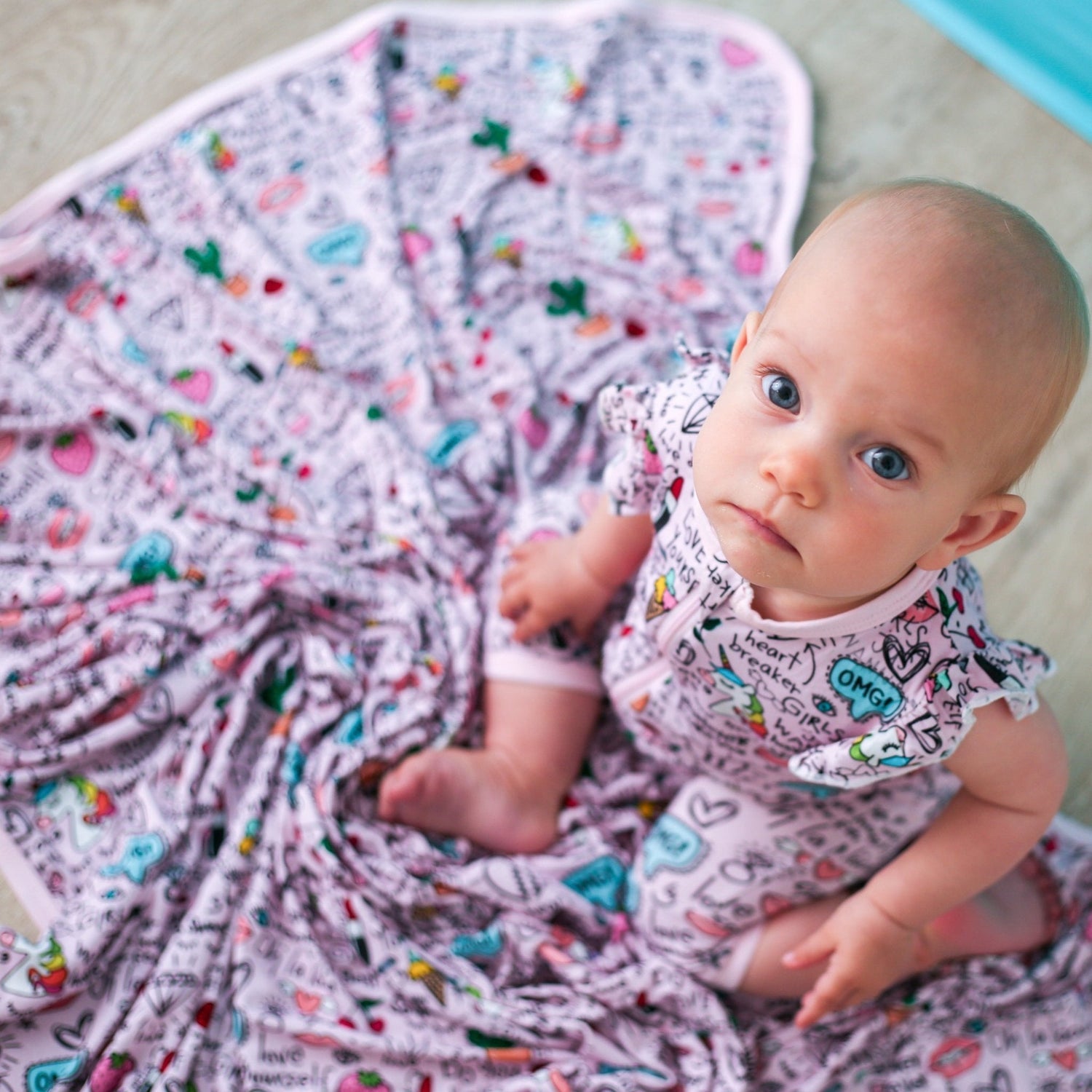 Dear Diary swaddle blanket with a soft printed pattern, spread out flat to show its large square shape
