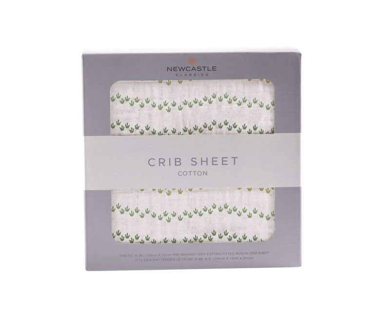 Dino Feet cotton muslin crib sheet in packaging, breathable and soft, fits standard mattresses.