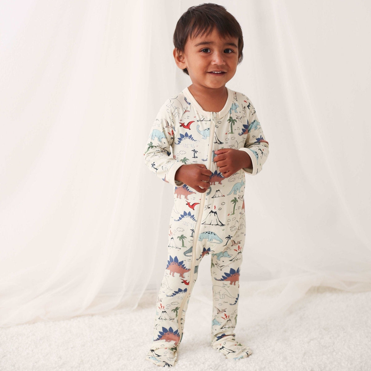 Baby footie pajamas with dinosaur print, full-length zipper, and covered feet