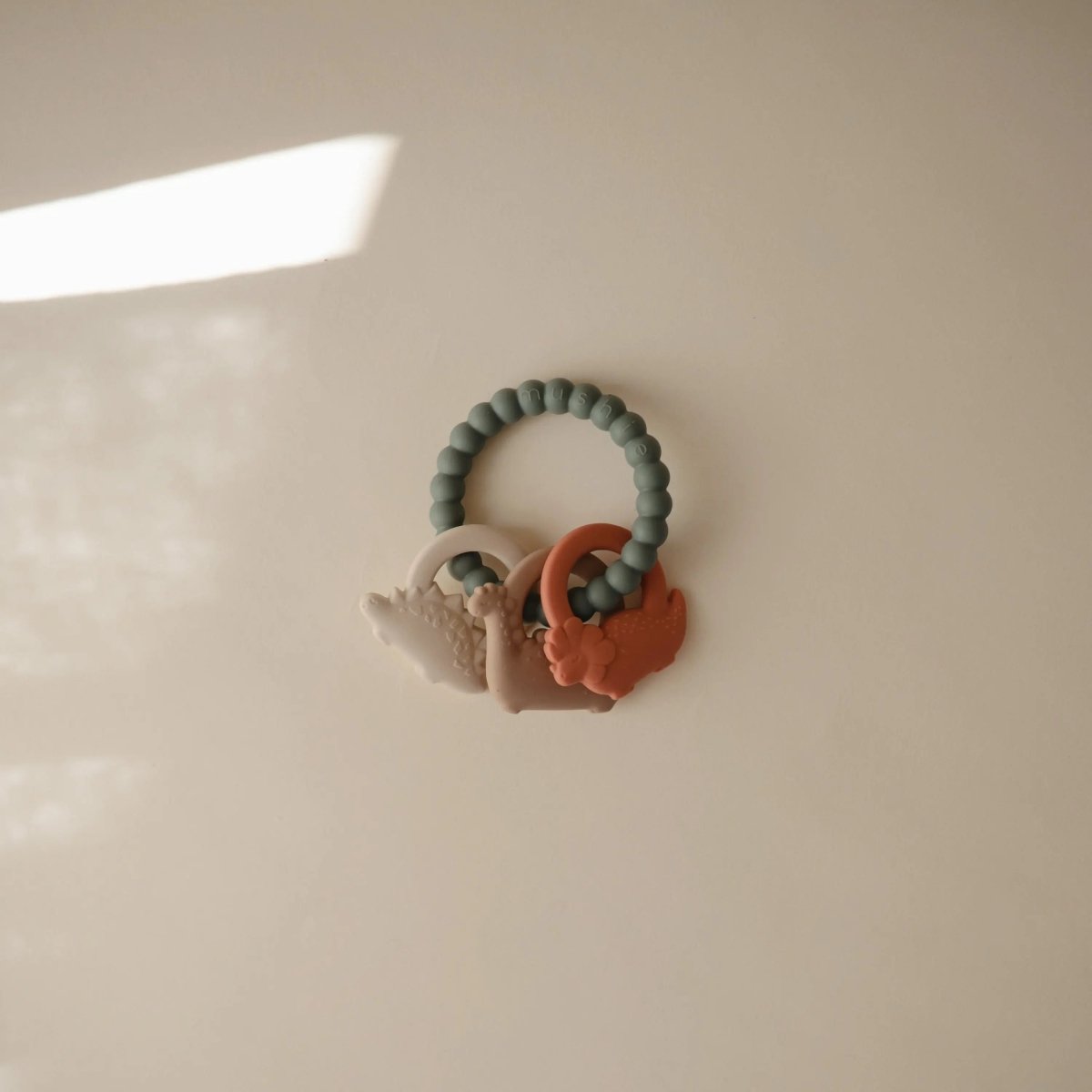 Mushie Dino Teething Ring with Sensory Shapes and Textures - Everetts Place Boutique - 