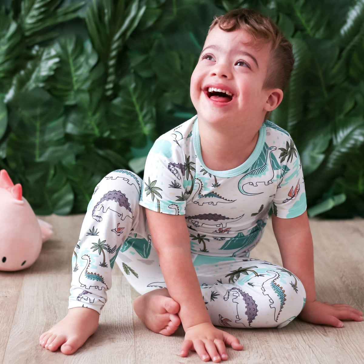 Two-piece kids pajama set with a dinosaur print, matching long-sleeve top and pants
