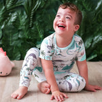 Two-piece kids pajama set with a dinosaur print, matching long-sleeve top and pants