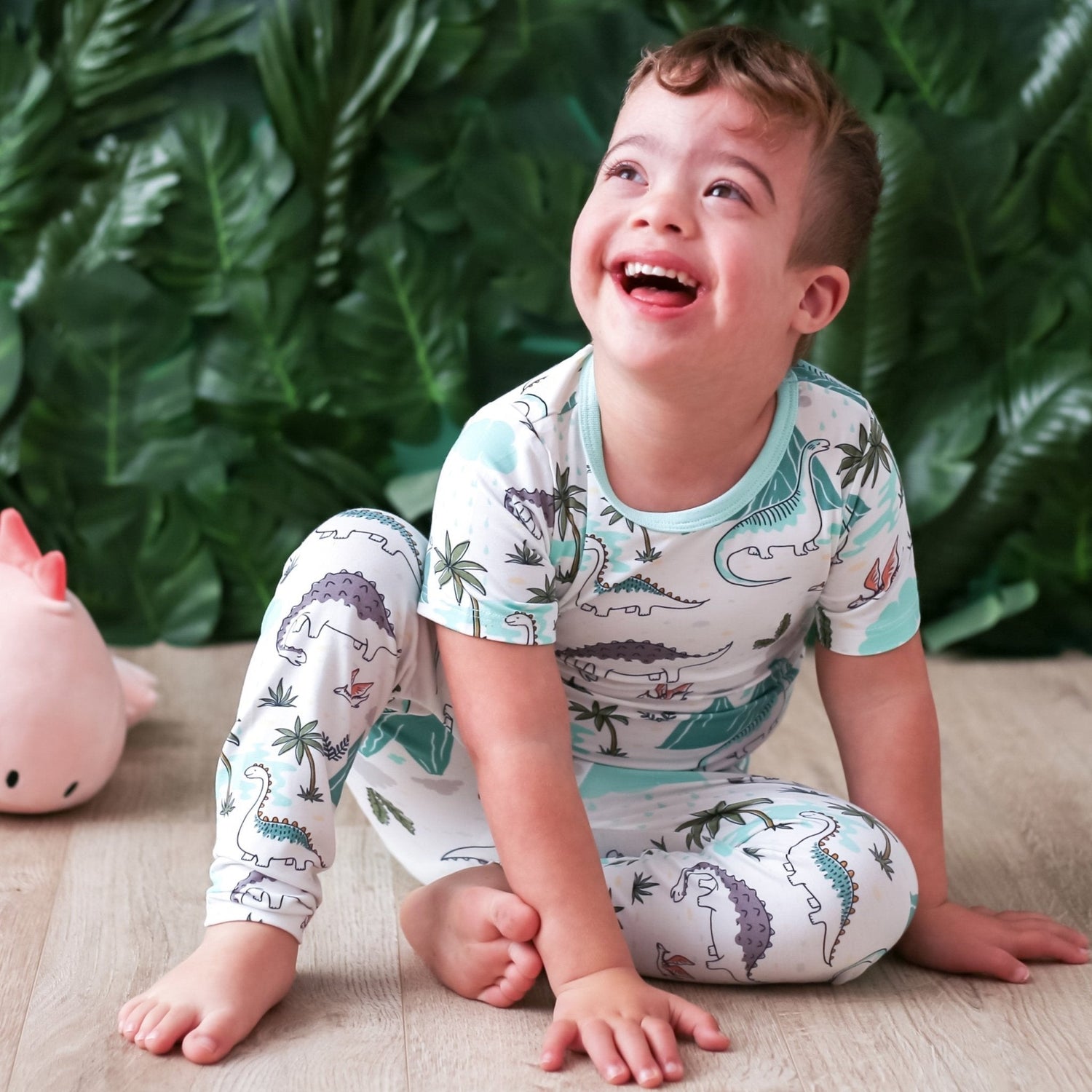 Two-piece kids pajama set with a dinosaur print, matching long-sleeve top and pants