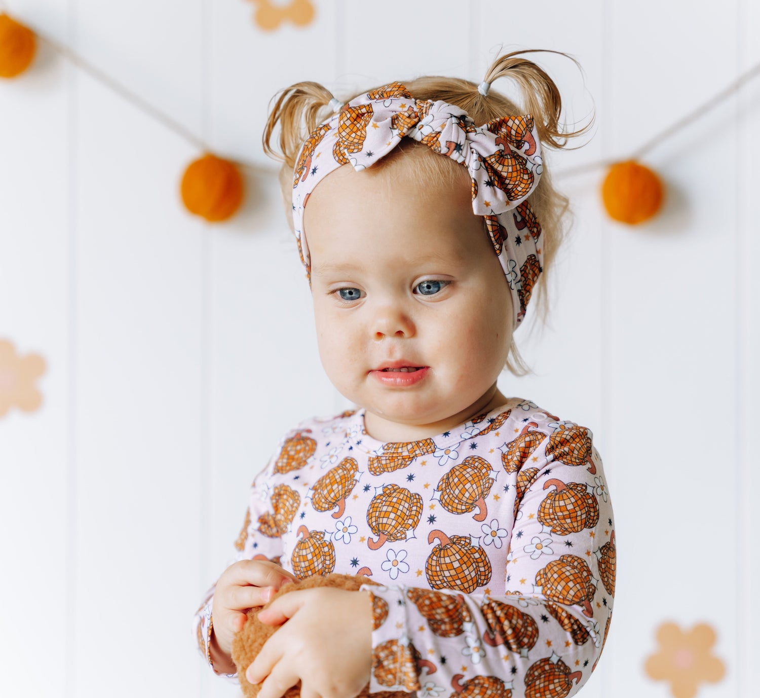Baby hair bow in a disco pumpkin print made from bamboo viscose fabric.